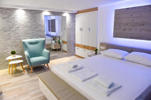 Postel nebo postele na pokoji v ubytování La Perla Apartments