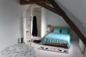 מיטה או מיטות בחדר ב-Domaine de Praline l'ensemble