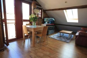 a living room with a table with chairs and a couch at Victorian Penthouse Apartment in Gloucester