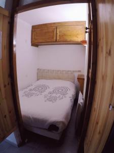 a small bedroom with a bed in a small room at Studio plein sud, Wifi, Parking in Thollon +19 photos