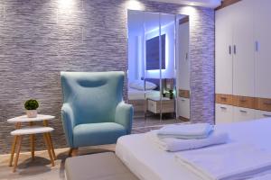 Postel nebo postele na pokoji v ubytování La Perla Apartments