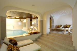 a house with a swimming pool and a living room at Haus Barbarahof in Altenmarkt im Pongau