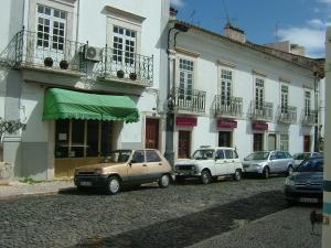 a group of cars parked in front of a building at Alentejano Low Cost Hotel in Estremoz