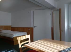 a bedroom with a bed and a table and a chair at Landgasthaus zur Linde in Fürstenhagen