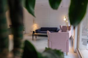 a living room with two chairs and a couch at Hotel Voramar in Benidorm