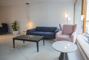 a living room with a couch and a table and a chair at Hotel Voramar in Benidorm