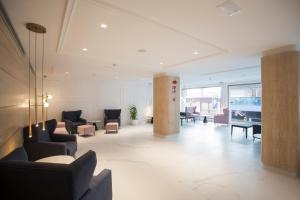 a lobby with couches and chairs in a building at Hotel Voramar in Benidorm