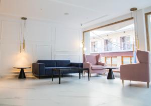 a living room with couches and chairs and a table at Hotel Voramar in Benidorm