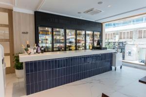 a bar in a restaurant with blue tile at Hotel Voramar in Benidorm