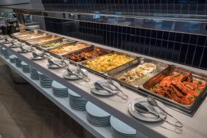 a buffet line with many different types of food at Hotel Voramar in Benidorm