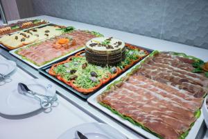 a table with several trays of food on it at Hotel Voramar in Benidorm