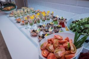 a buffet with bowls of food on a table at Hotel Voramar in Benidorm