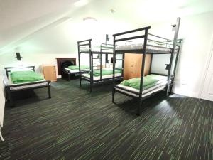 a room with two bunk beds and a desk at YHA London Earl's Court in London