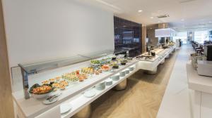 a buffet line with many plates of food at Hotel Voramar in Benidorm