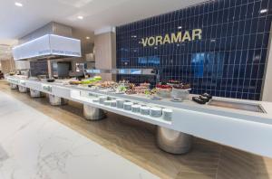 a buffet line of food in a restaurant at Hotel Voramar in Benidorm
