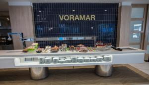 a display case in a store with a table of food at Hotel Voramar in Benidorm