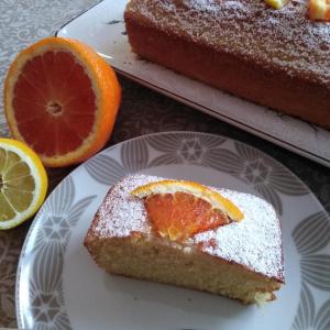 a piece of orange cake on a plate with a slice missing at Bed and Breakfast Ai Sassi in Sovramonte