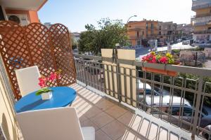 a balcony with a table and chairs and a street at B&B New Triscele in Sciacca