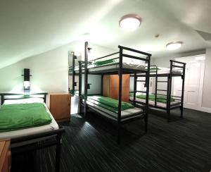a room with three bunk beds in it at YHA London Earl's Court in London