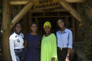 a group of women standing in front of a building at Kivu Paradis Resort in Nyamyumba