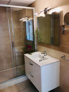 a bathroom with a white sink and a shower at Apartamentos Aguas Blancas in Santa Eularia des Riu