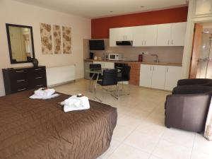 a bedroom with a bed with two towels on it at Hill View Hotel Apartments in Pissouri