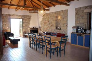 a kitchen and dining room with a wooden table and chairs at SPITI MAS in Proástion