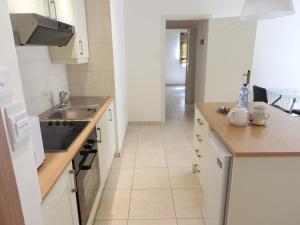 a kitchen with white cabinets and a sink at Hill View Hotel Apartments in Pissouri