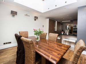 a dining room with a wooden table and chairs at 31 Queens Terrace in Southampton