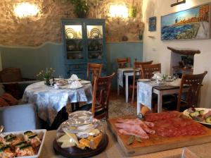 a restaurant with a table with food on it at Los Cuatro Vientos B&B in Torre del Rico