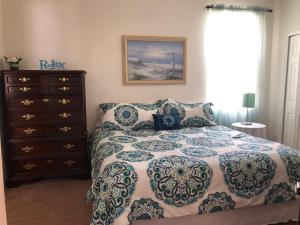 a bedroom with a bed and a dresser at Disney's Great Escape's Villa! 15 Minutes From Disney in Davenport +52 photos
