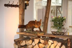 a cat that is standing on top of a log at Hotel Garni Kaiserpfalz in Goslar