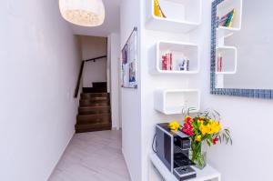 a hallway with a vase of flowers on a tv at Villa Flores Room in Dubrovnik