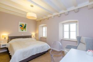a bedroom with a bed and a table and a chair at Villa Flores Room in Dubrovnik