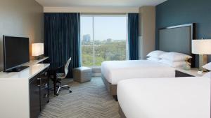 a hotel room with two beds and a television at Hyatt Regency Atlanta Perimeter at Villa Christina in Atlanta