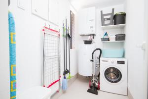 a laundry room with a washer and dryer at Urbano Blanco Apartments in Calpe
