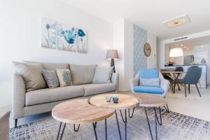a living room with a couch and a table at Urbano Blanco Apartments in Calpe