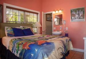 a bedroom with a large bed and a sink at Caribbean House, No Resort Fees in Key West