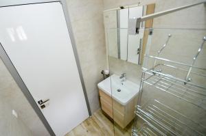 a bathroom with a sink and a shower with a mirror at Casa del Sole Lux in Kotor