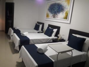 Postel nebo postele na pokoji v ubytování Hotel Girón Plaza