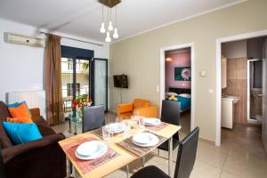 a dining room and living room with a table and chairs at Sophia Central Loft & Apartments in Argostoli +26 photos