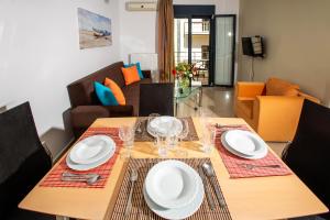 a dining room with a table with plates and glasses at Sophia Central Loft & Apartments in Argostoli