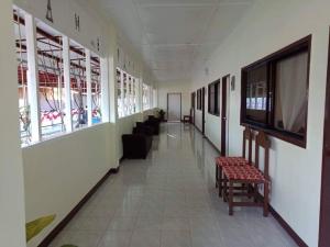 a hallway with chairs and a television in a building at Johann Ritz Place in Dumanjug