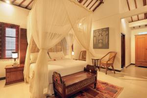 Voodi või voodid majutusasutuse Puri Mas Boutique Resort & Spa toas