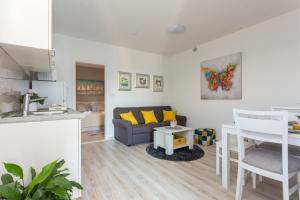 a living room with a couch and a table at Apartments Maximus in Dubrovnik