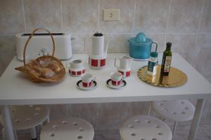 a table with cups and bottles of wine on it at La Casa de Manuel in Portomarin