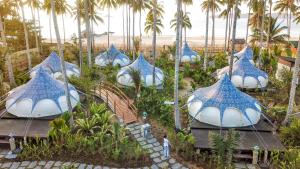 an aerial view of a resort with blue and white structures at Nacpan Beach Glamping Managed by H Hospitality Group in El Nido
