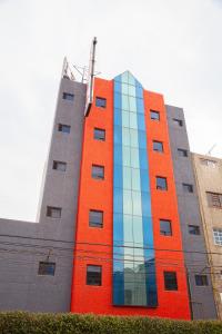 a building with an orange and blue at Hotel Ancona - S&oacute;lo Adultos in Mexico City