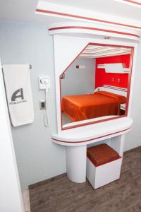 a mirror in a room with a bed in it at Hotel Ancona - S&oacute;lo Adultos in Mexico City
