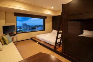 a bedroom with a bunk bed and a large window at Urayasu Brighton Hotel Tokyo Bay in Urayasu